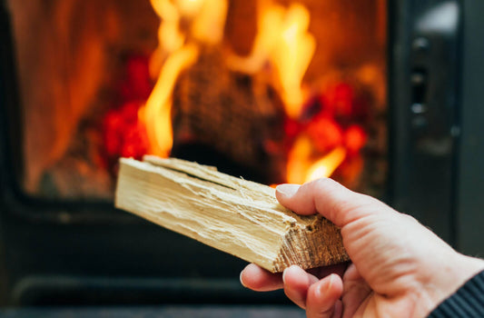 Block of wood being put into fireplace